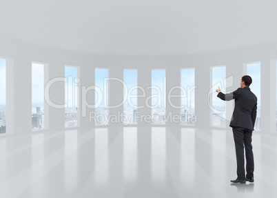 Composite image of asian businessman pointing