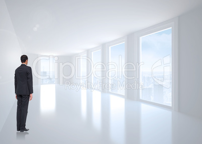 Composite image of businessman turning his back to camera