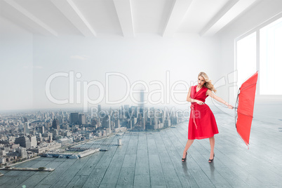 Composite image of elegant blonde holding umbrella