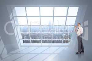 Composite image of thinking businessman holding glasses