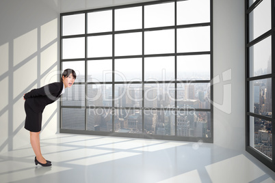 Composite image of surprised businesswoman bending