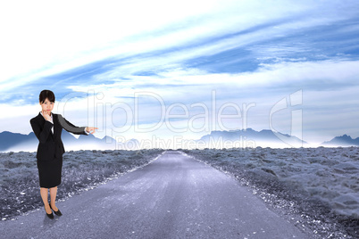 Composite image of businesswoman pointing