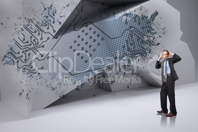 Composite image of stressed businessman with hands on head