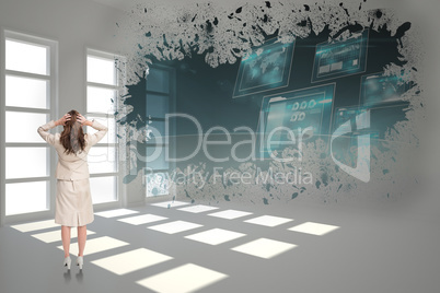 Composite image of businesswoman with hands on head standing bac