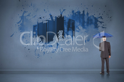 Composite image of businessman holding umbrella Composite image of businessman holding umbrella