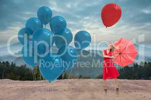 Composite image of elegant blonde holding umbrella