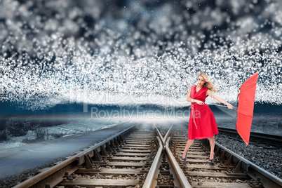 Composite image of elegant blonde holding umbrella