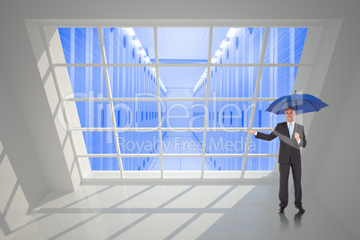 Composite image of peaceful businessman holding blue umbrella