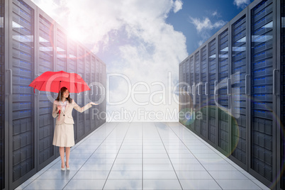 Composite image of attractive businesswoman holding red umbrella