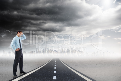 Composite image of thoughtful businessman with hand on head