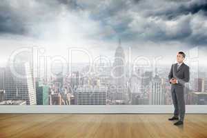 Composite image of businessman with hands folded