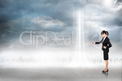 Composite image of focused businesswoman pointing