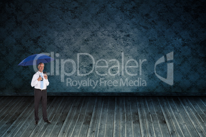 Composite image of happy businessman holding umbrella