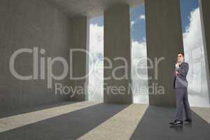 Composite image of thoughtful businessman holding pen to chin