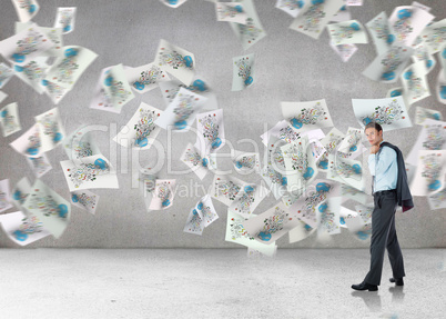 Composite image of serious businessman holding his jacket