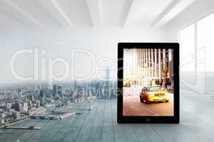 Composite image of yellow taxi on tablet screen