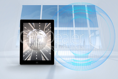 Composite image of silver globe on tablet screen