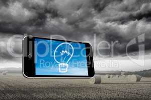Composite image of cloud light bulb on smartphone screen