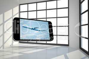 Composite image of airplane on smartphone screen