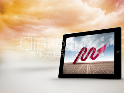 Composite image of red arrow on tablet screen