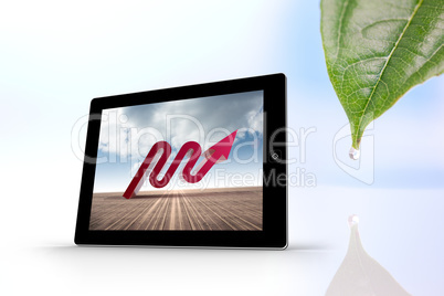 Composite image of red arrow on tablet screen