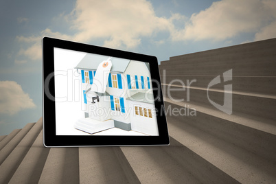 Composite image of house with price tag on tablet screen