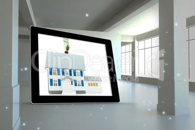 Composite image of house with price tag on tablet screen