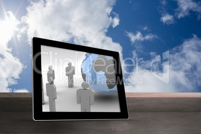 Composite image of figures and earth on tablet screen