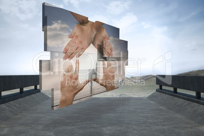 Composite image of hands making a house on abstract screen