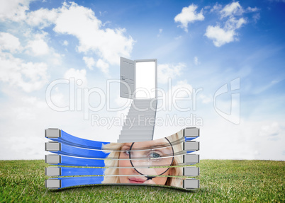 Composite image of blonde with magnifying glass on abstract scre