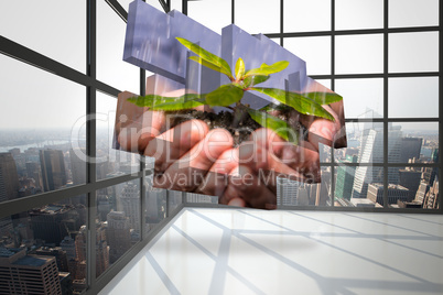 Composite image of hands holding shrub on abstract screen