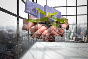 Composite image of hands holding shrub on abstract screen
