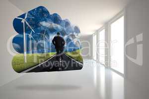 Composite image of businessman on road on abstract screen