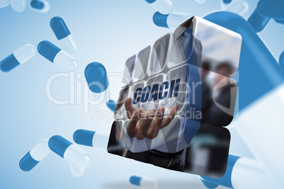 Composite image of businessman holding coach text on abstract sc