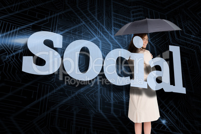 Businesswoman holding umbrella behind the word social