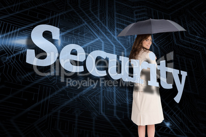Businesswoman holding umbrella behind the word security