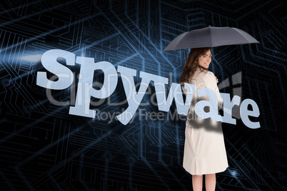 Businesswoman holding umbrella behind the word spyware