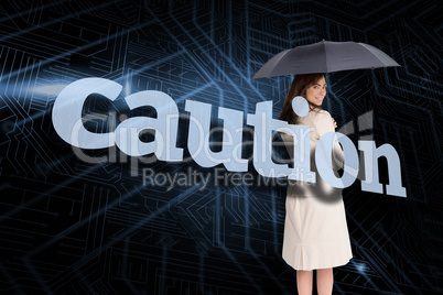 Businesswoman holding umbrella behind the word caution