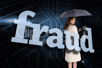 Businesswoman holding umbrella behind the word fraud