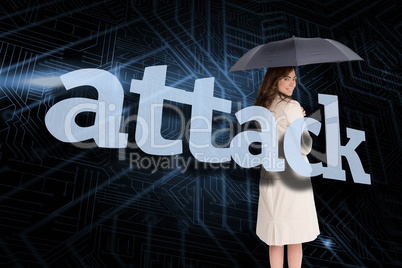 Businesswoman holding umbrella behind the word attack