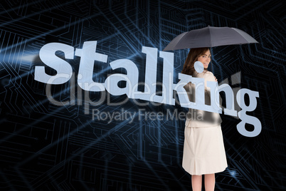 Businesswoman holding umbrella behind the word stalking