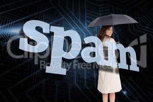 Businesswoman holding umbrella behind the word spam