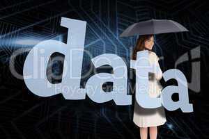 Businesswoman holding umbrella behind the word data