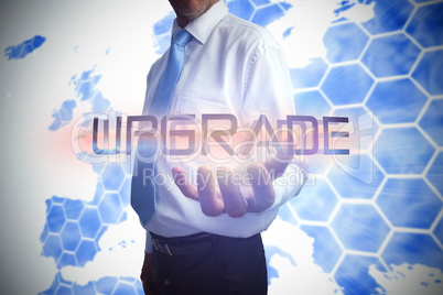 Businessman presenting the word upgrade