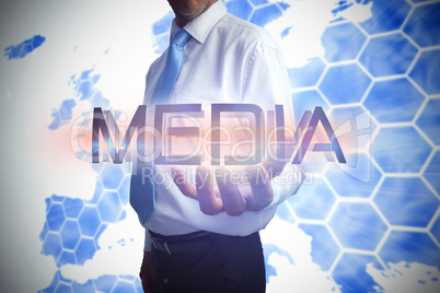 Businessman presenting the word media