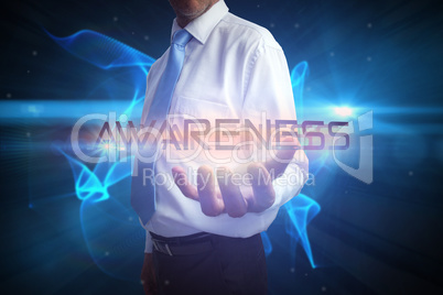 Businessman presenting the word awareness