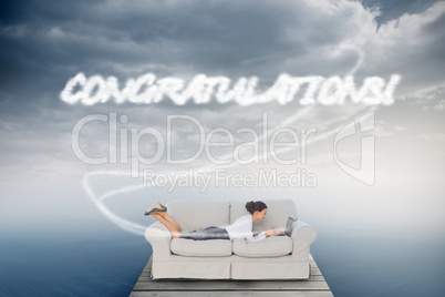 Congratulations! against cloudy sky over ocean