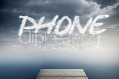 Phone against cloudy sky over ocean