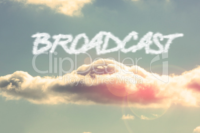 Broadcast against bright blue sky with cloud