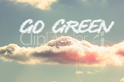 Go green against bright blue sky with cloud